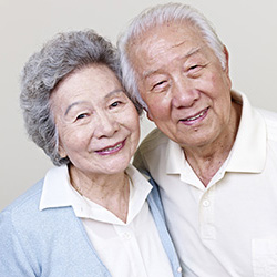 an elderly couple smiling